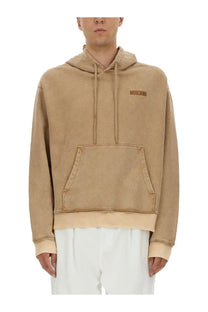 Beige moschino men’s sweatshirt with subtle faded texture and matching drawstrings in brown tone