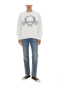 Moschino men’s white sweatshirt with navy blue embroidered logo featuring laurel wreath and crossed swords