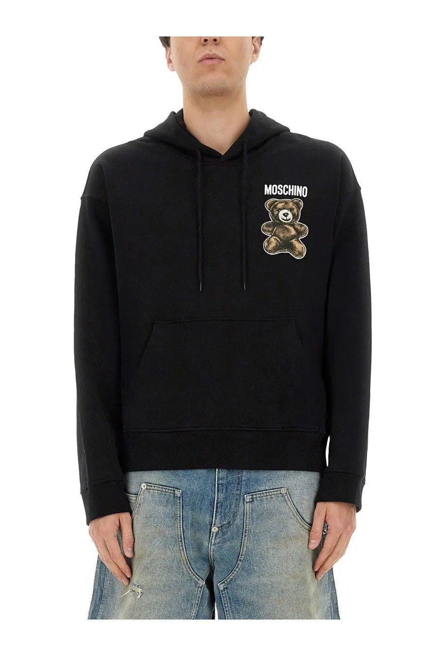 Black Moschino men’s hoodie featuring a brown embroidered teddy bear patch with the brand name above it