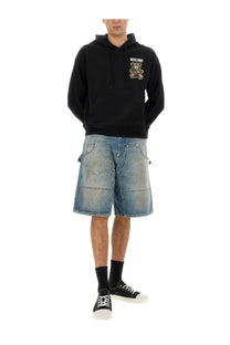 Black Moschino men’s hoodie featuring an embroidered teddy bear logo on the chest in cotton fabric