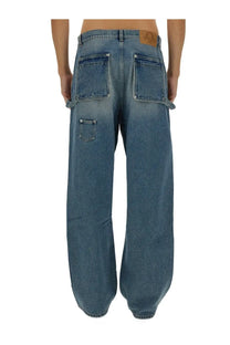 Back view of moschino men’s wide leg blue denim jeans with faded wash two large pockets and waistband patch
