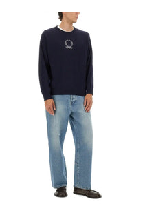 Navy blue Moschino men’s wool and cashmere knit sweater with white embroidered laurel wreath logo on the chest