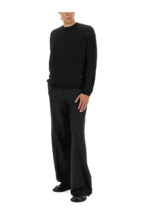 Moschino men’s black long-sleeved wool and silk pullover sweater with subtle texture and small metallic logo on left chest