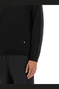 Black long-sleeved knit sweater with small white m logo made of wool and silk from moschino men’s pullover collection