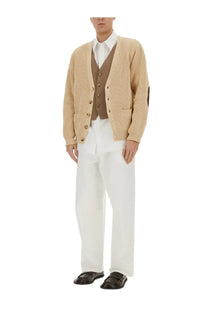 Beige ribbed knit cardigan with brown button accents and patch pockets complementing moschino men’s wristwatch print shirt white