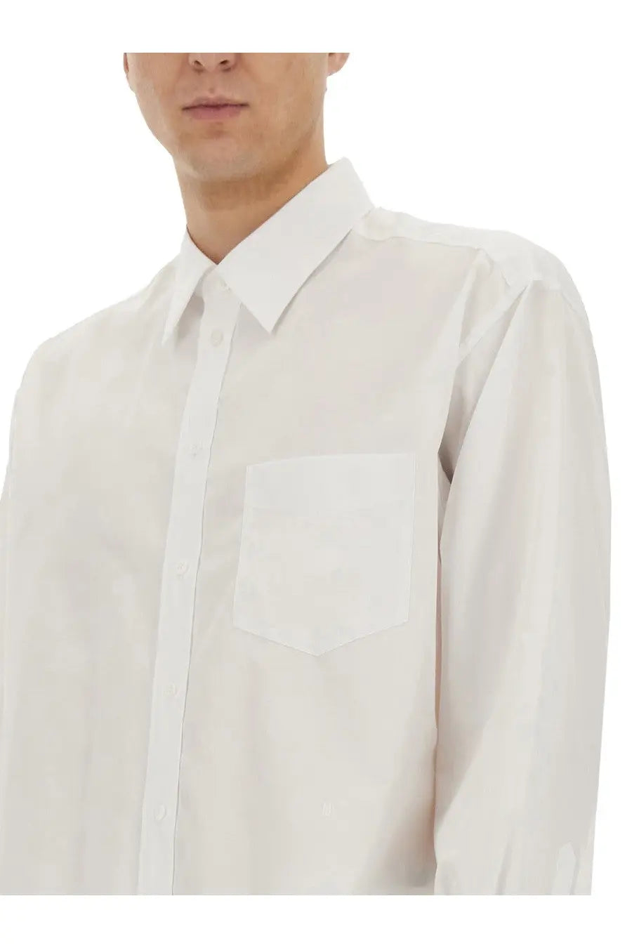 A crisp white Moschino men’s long-sleeved button-down shirt with classic collar and chest pocket featuring wristwatch print