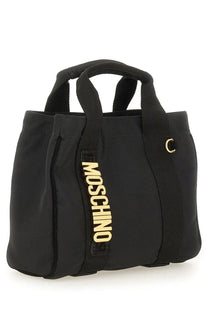Moschino women’s black tote bag with gold-tone lettering and a metallic c-shaped clasp in leather material