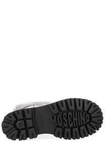 Black rubber sole with embossed moschino branding and textured tread on moschino women’s boot zipper black