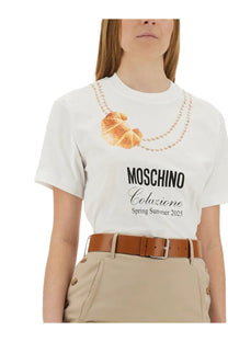 Moschino women’s white cotton t-shirt with printed croissant, pearl necklace detail, and colazione spring summer 2025 text