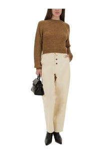 Cream-colored high-waisted trousers with button-front design styled with moschino women’s brown cropped shirt