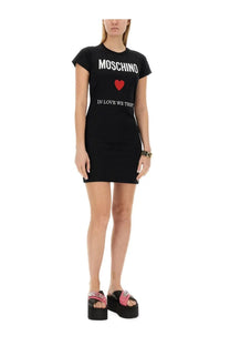 Moschino women’s black t-shirt dress with white moschino lettering red heart emblem and in love we trust print