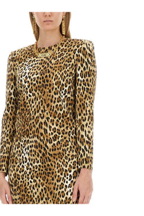 A woman wearing a moschino women’s long-sleeved fitted leopard print dress in satin-like black and tan fabric