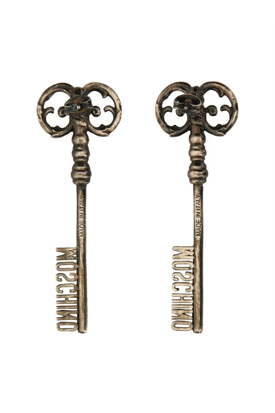 Moschino women’s silver key-shaped earrings with intricate scrollwork and the brand name engraved on the shaft