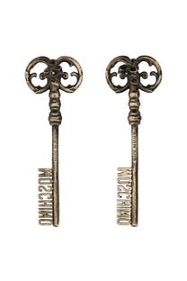 Moschino women’s silver key-shaped earrings with intricate scrollwork and the brand name engraved on the shaft