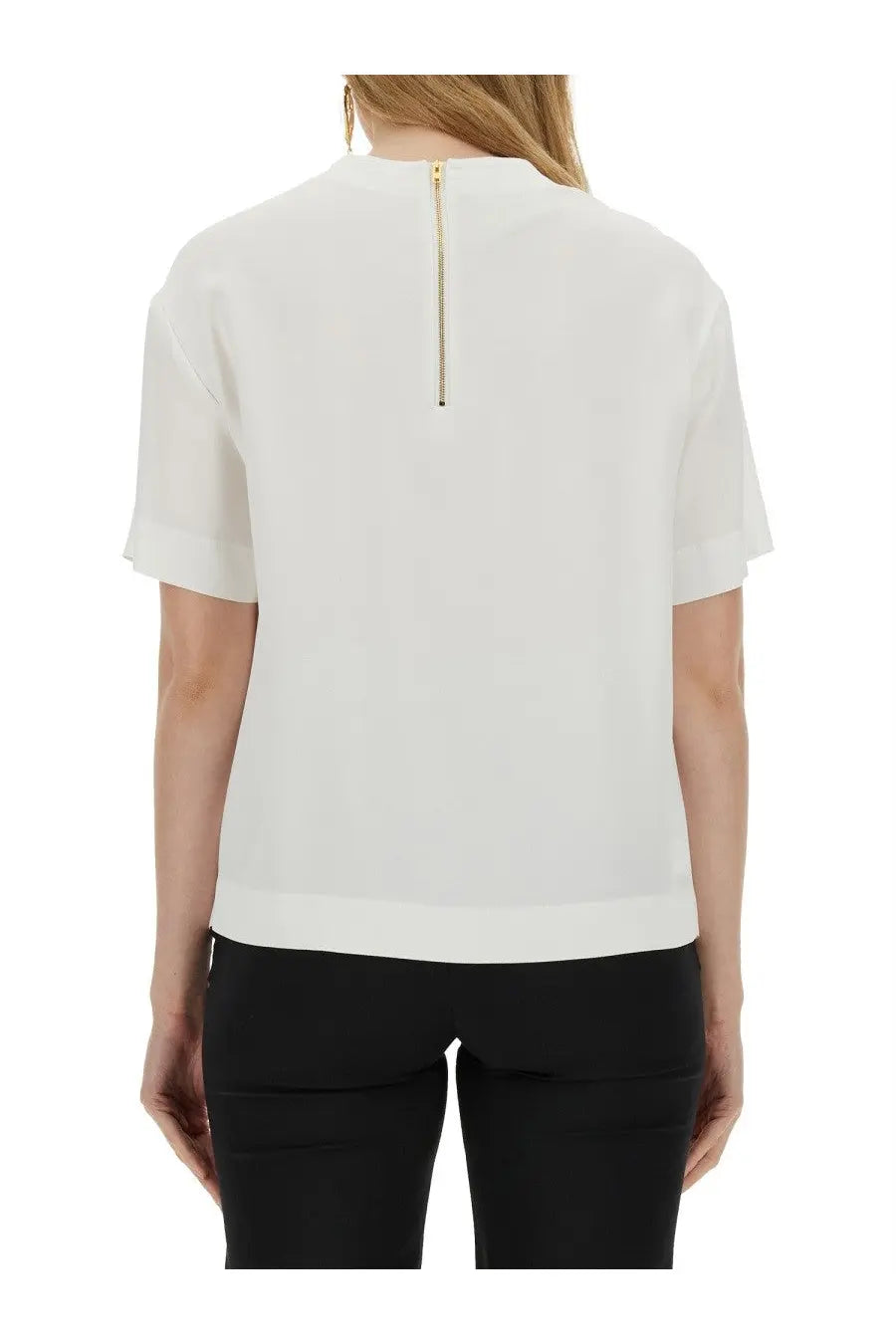 Back view of Moschino women’s gone white white short-sleeved blouse with gold zipper and subtle hemline