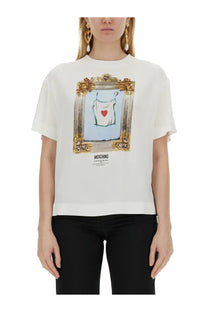 Moschino women’s white t shirt featuring a framed graphic of a white garment with a red heart and gold border
