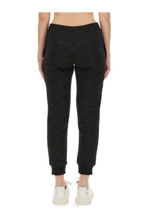 Black moschino women’s joggers with repeating embossed logo pattern across the fabric for casual wear