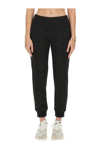 Moschino women’s black joggers with a subtle textured weave featuring a repeating love logo pattern
