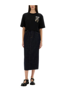 Black Moschino t-shirt with embroidered teddy bear logo on chest paired with women’s long blue denim skirt