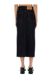 Dark indigo denim midi skirt by Moschino with a brown leather brand patch at the waistband back side view