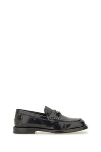 Black patent leather Moschino women’s moccasin Berlin loafer with gold-tone logo on the strap