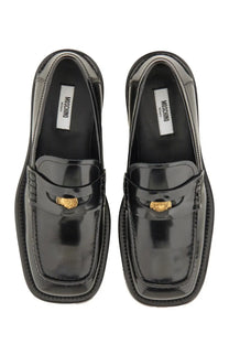 Moschino women’s black patent leather moccasin loafers with gold tone medusa head buckles and square toe