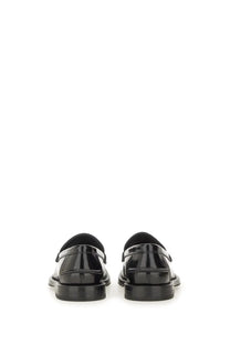 Moschino women’s moccasin Berlin black black patent leather loafers with sleek glossy finish and classic slip on design