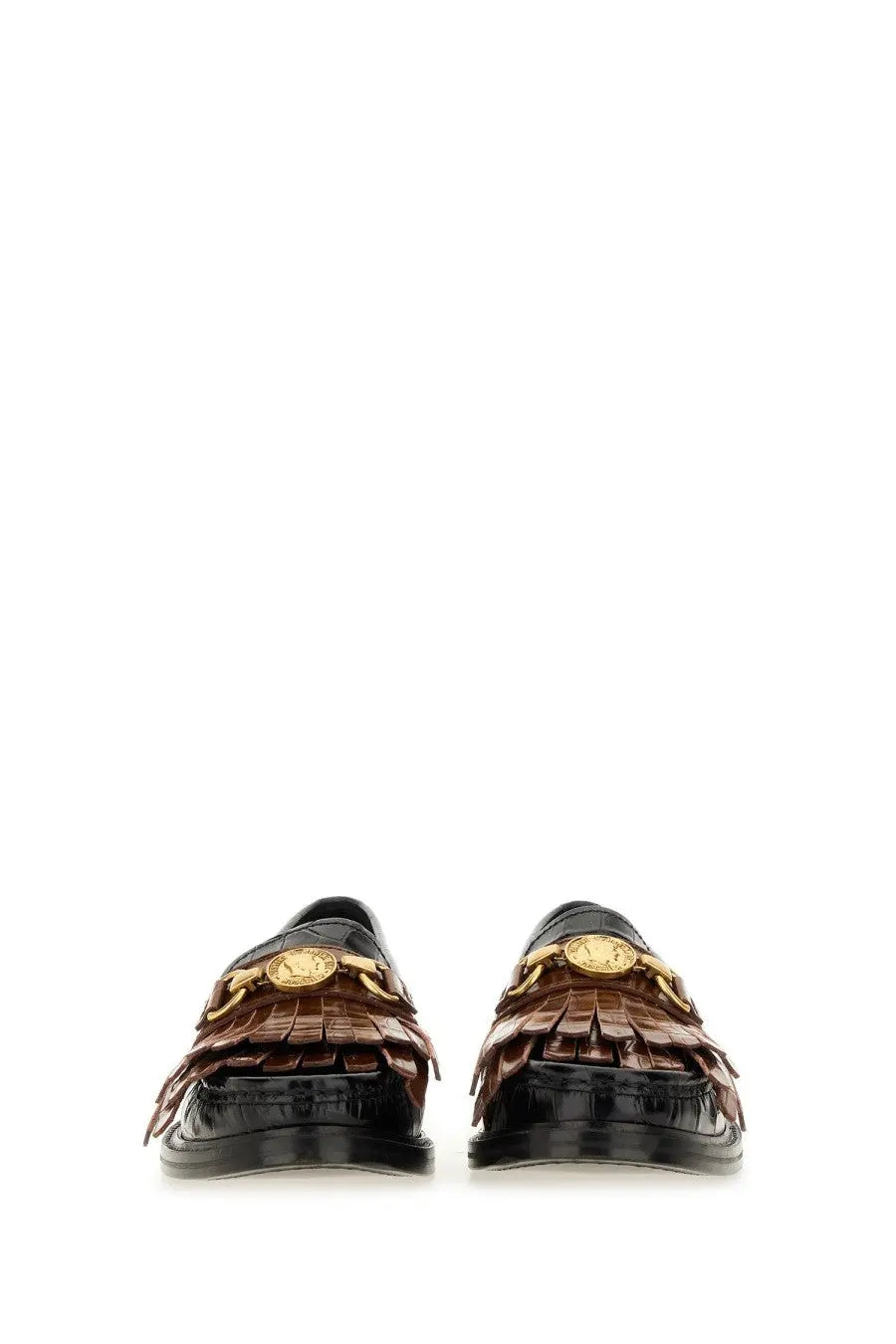 Moschino women’s black moccasin featuring brown crocodile-embossed leather, gold medusa head hardware, and fringed detailing