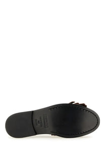 Black leather Moschino women’s moccasin sandal with a small brown bow detail on the toe