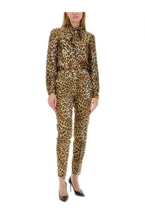 Moschino women’s leopard print long-sleeved jumpsuit with high collar and tied bow for stylish wear