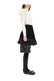 Black leather handbag with structured rectangular shape and front buckle closure complementing moschino women’s polka dots skirt black