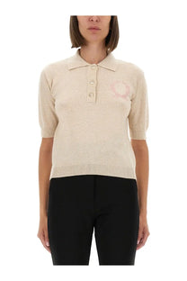 Beige knitted polo shirt by Moschino with a subtle pink embroidered logo on the chest for women