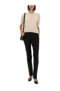 Moschino women’s beige short-sleeved knit polo shirt with subtle pink floral embroidery on the left chest