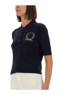 Navy blue knitted polo shirt with white embroidered laurel wreath logo on chest from Moschino women’s collection