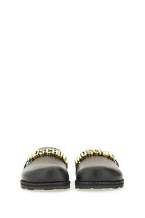 Moschino women’s sabot black leather slide sandals with bold gold-tone moschino lettering strap
