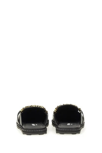 Moschino women’s sabot black leather slide sandals with gold-tone metal detailing on the back edge viewed from back