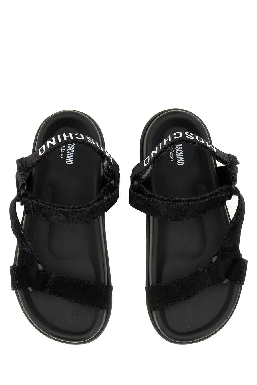 Moschino women’s black strap sandals with suede look and glossy black rubber sole featuring white logo on footbed