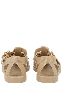 Beige translucent Moschino women’s Sandalo Jelly sandals with gold-tone chain detailing and embossed branding
