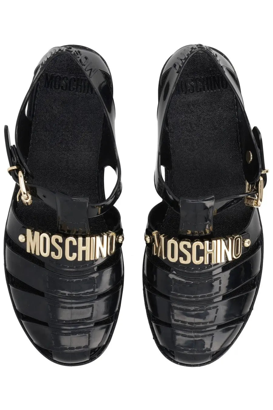 Moschino women’s black glossy patent leather sandals with gold-tone Moschino lettering across the front