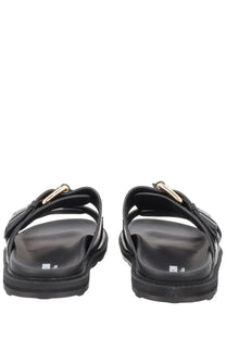 Moschino women’s black leather slide sandals with gold-tone buckle accents for stylish casual wear