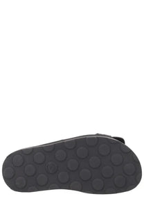 Black rubber sole with circular tread pattern on the back of moschino women’s sandalo tie black sandal