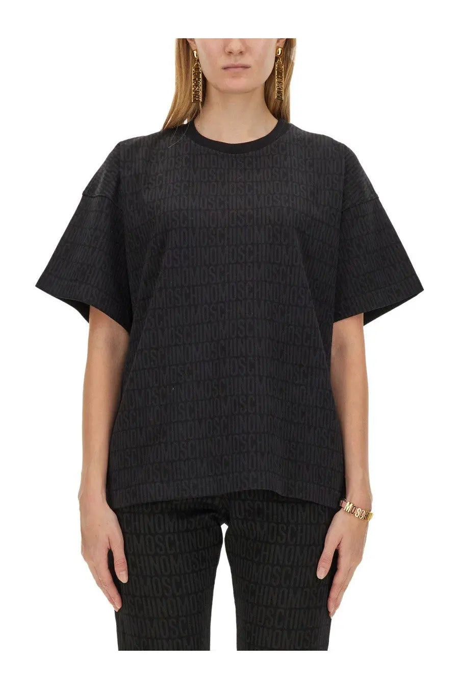 Moschino women’s black oversized t shirt with subtle embossed repeating logo pattern on soft fabric