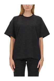 Moschino women’s black oversized t shirt with subtle embossed repeating logo pattern on soft fabric