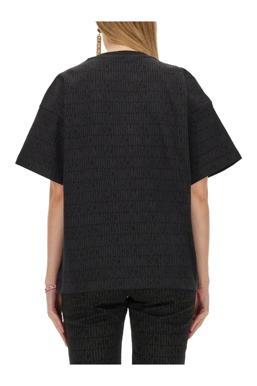 Moschino women’s black short-sleeved shirt with subtle embossed repeating logo pattern on soft fabric