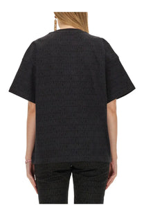 Moschino women’s black short-sleeved shirt with subtle embossed repeating logo pattern on soft fabric
