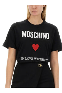Moschino women’s black t-shirt with bold white lettering and a red heart emblem on the front