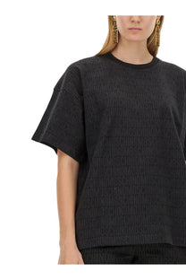 Moschino women’s black t-shirt featuring a repeating embossed logo pattern on soft fabric