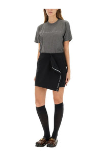 Black wrap skirt with white text detailing along the side seam paired with moschino womens grey shirt