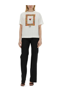 Moschino women’s white short-sleeved cotton t-shirt with colorful framed heart graphic and brand name print below