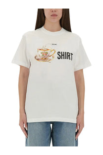 Moschino white cotton t-shirt with ornate floral teacup illustration and bold black shirt lettering on front